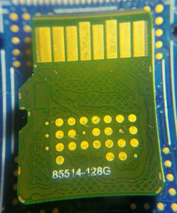 Test pads exposed on SanDisk High Endurance 128GB microSDXC card.