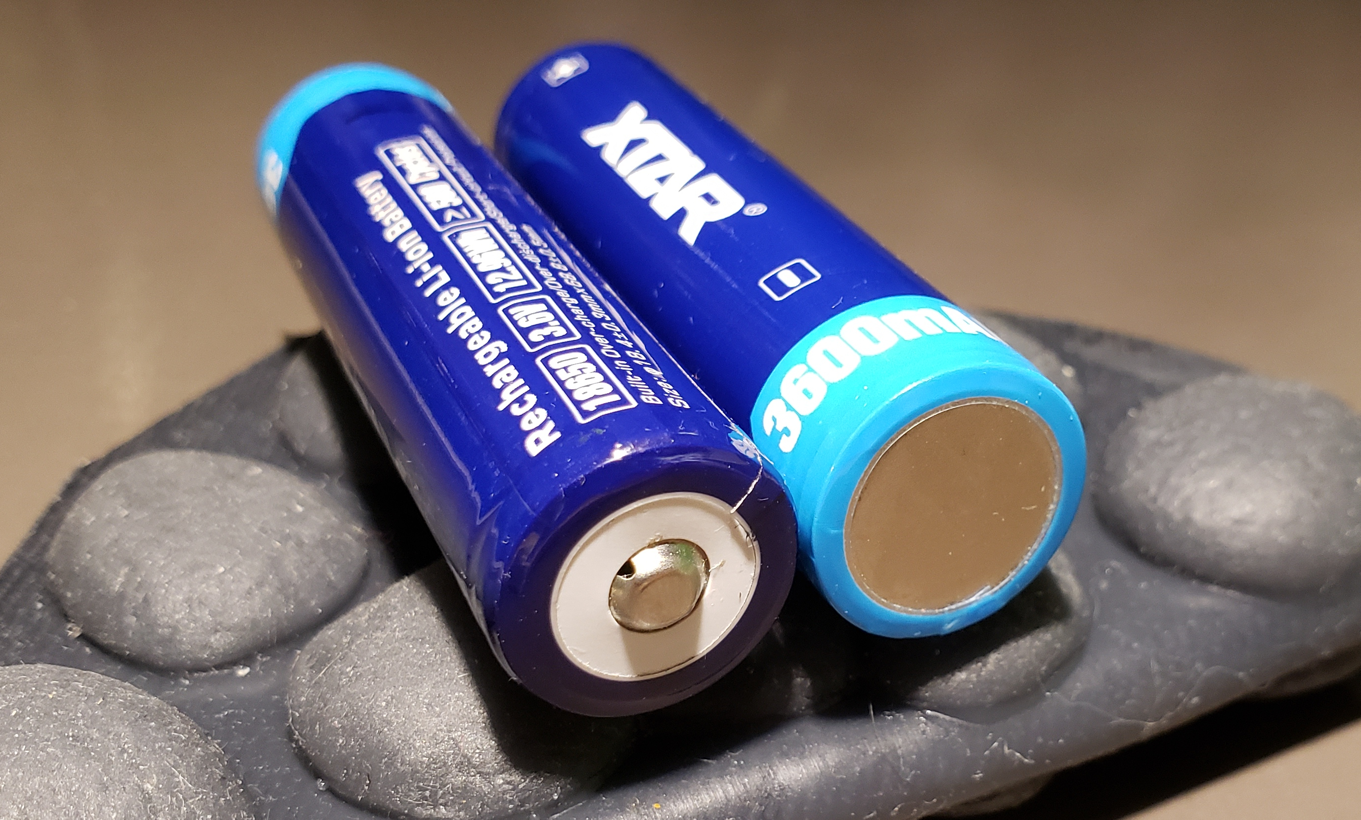 Positive and negative terminals of the XTAR 3600mAh protected 18650 battery.